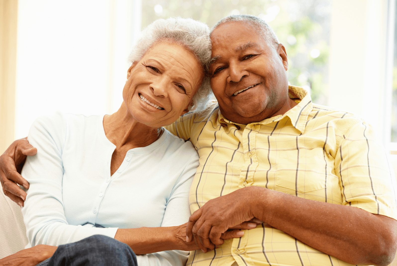 An older couple sitting together and smiling